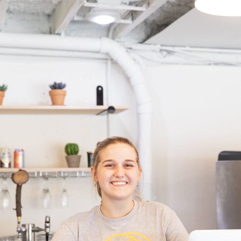Happy Kesos Tacos team member at the counter