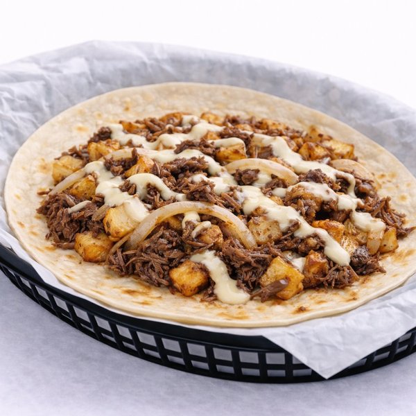 Barbacoa taco — shredded beef barbacoa with roasted peppers and toppings
