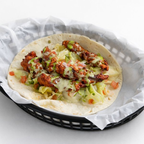 Fire Chick taco — hand-battered fried chicken tossed in Fire Red salsa on a flour tortilla