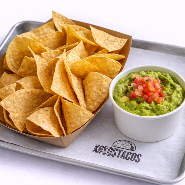 Fresh guacamole topped with pico de gallo and homemade tortilla chips