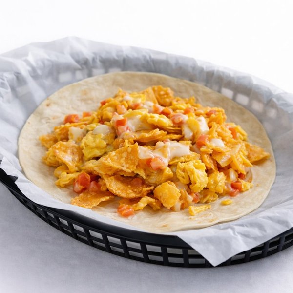 Migas breakfast taco Austin — eggs, crispy tortilla strips, queso